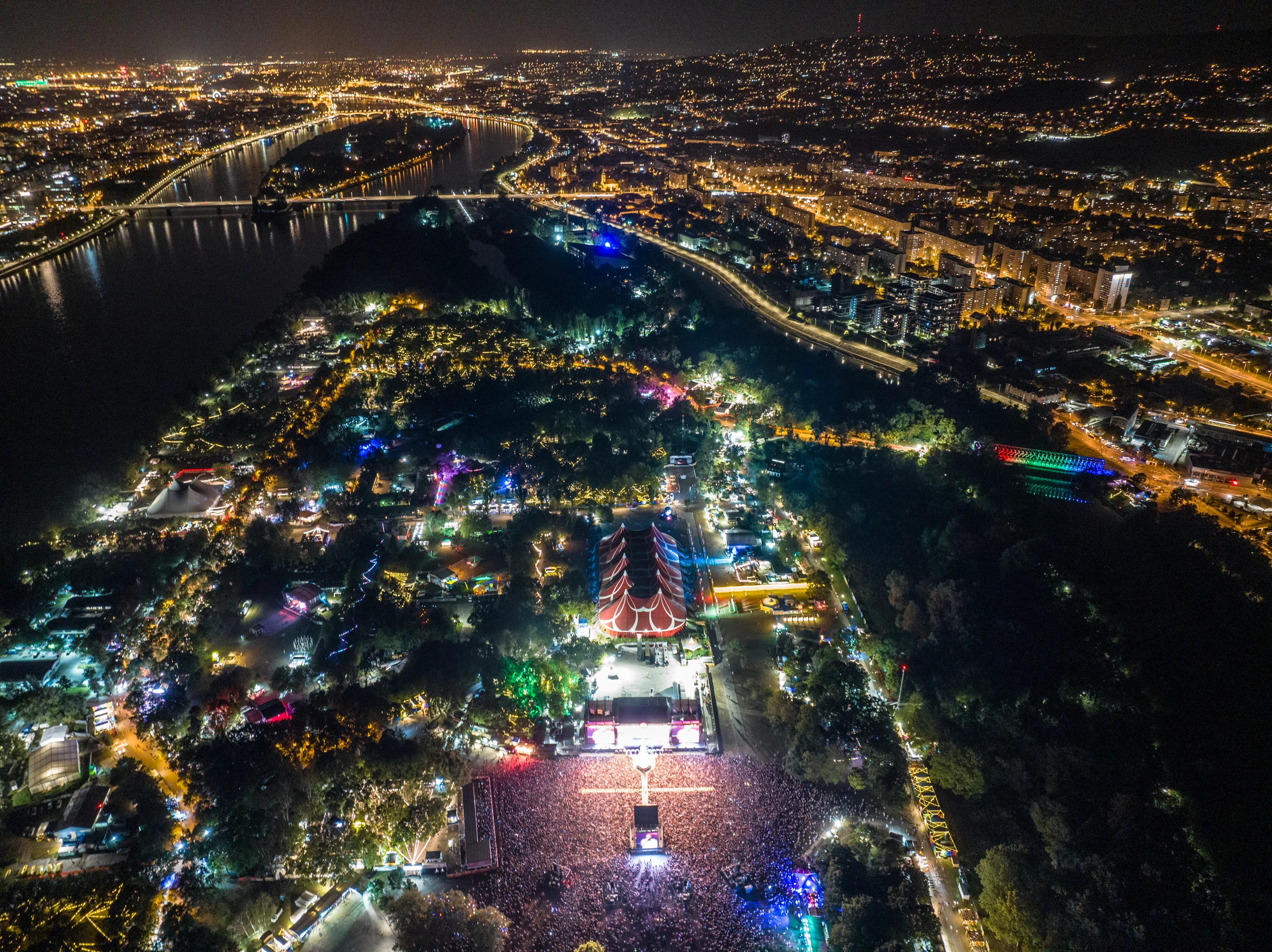 Night-time aerial view of Sziget Festival, the Danube and Budapest, photographed by Péter Kálló